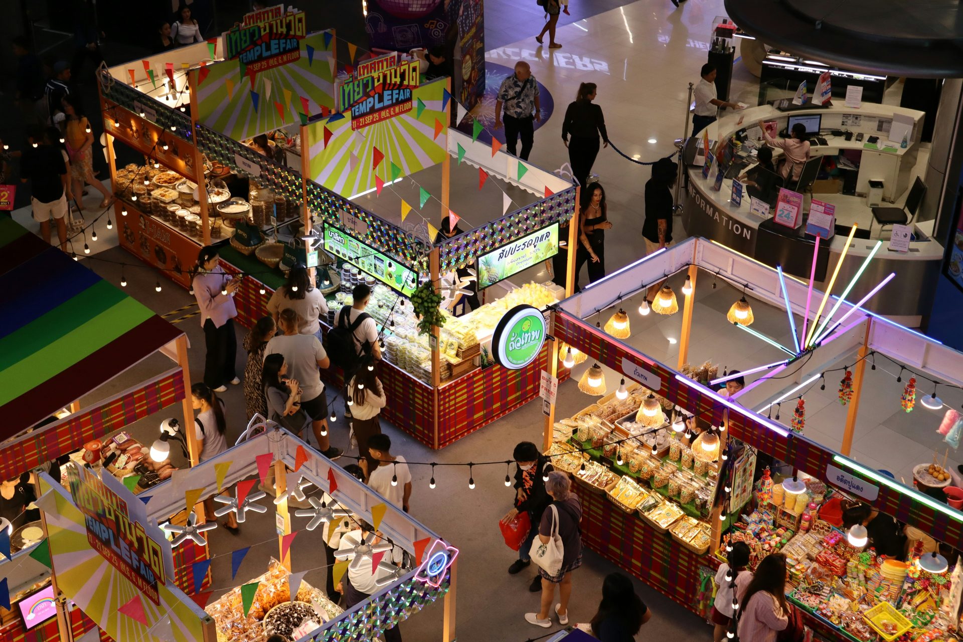 People browsing stalls at a vibrant indoor market